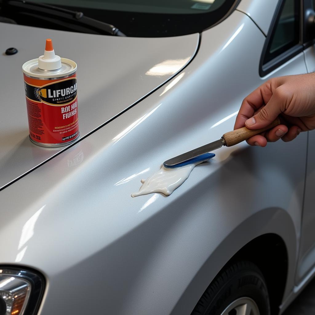 Applying Body Filler to Car Hood