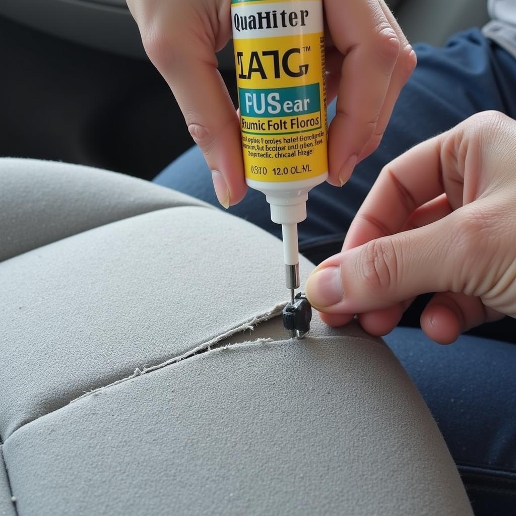 Repairing a tear in a car seat with fabric glue.