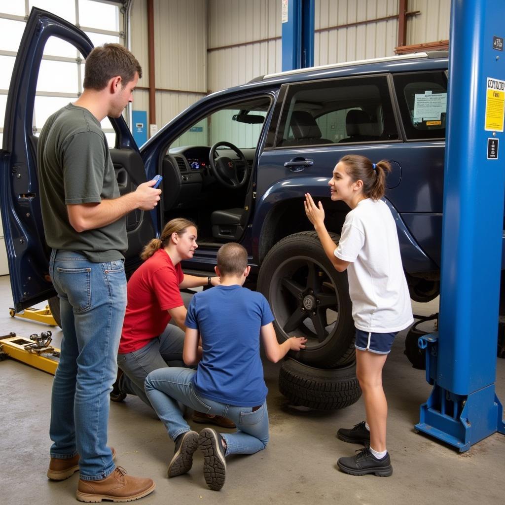 Students Practicing a Tire Change in a Car Maintenance Class in NYC