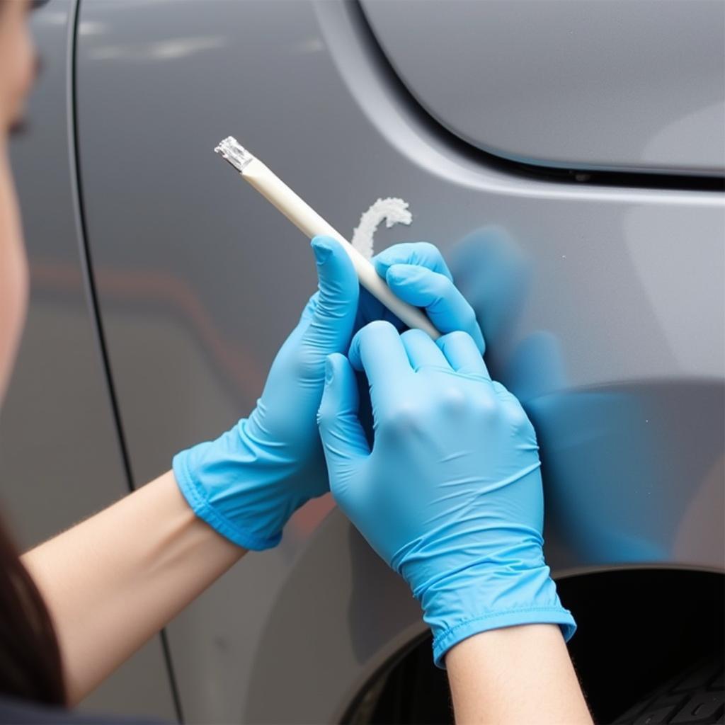 Applying touch-up paint to a car chip