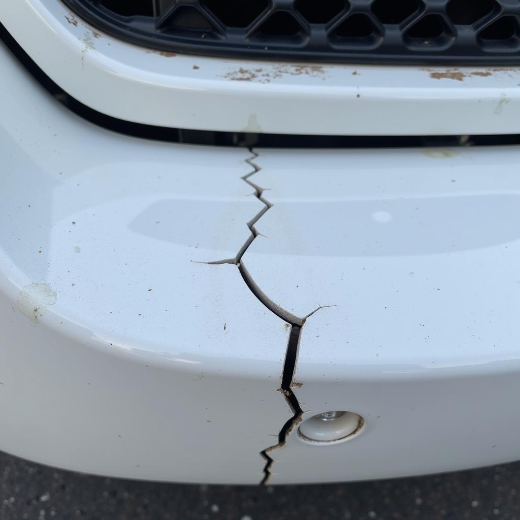 Close-up of a cracked car bumper