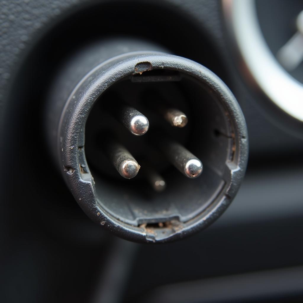 Damaged car AC adapter socket with bent contacts