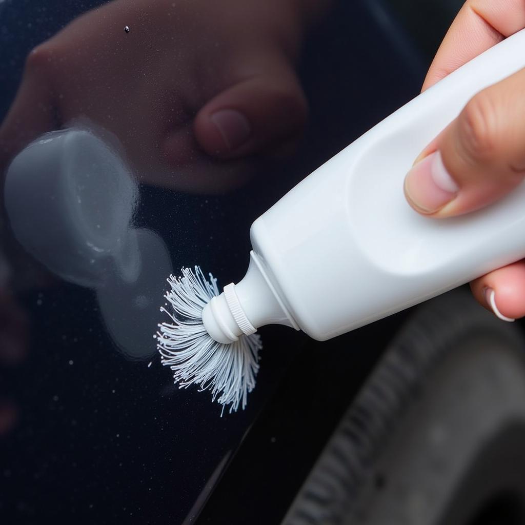 Applying toothpaste on car scratch