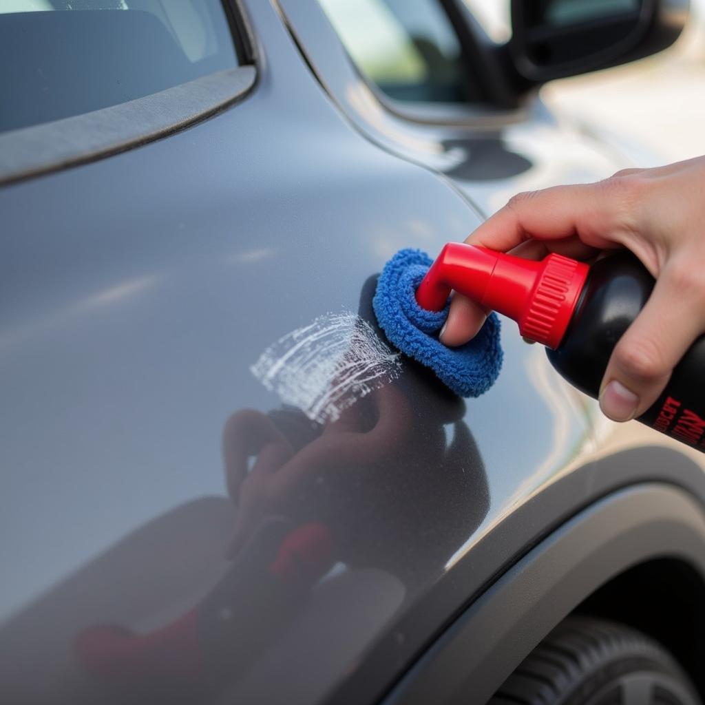 Applying car scratch remover to a minor scratch