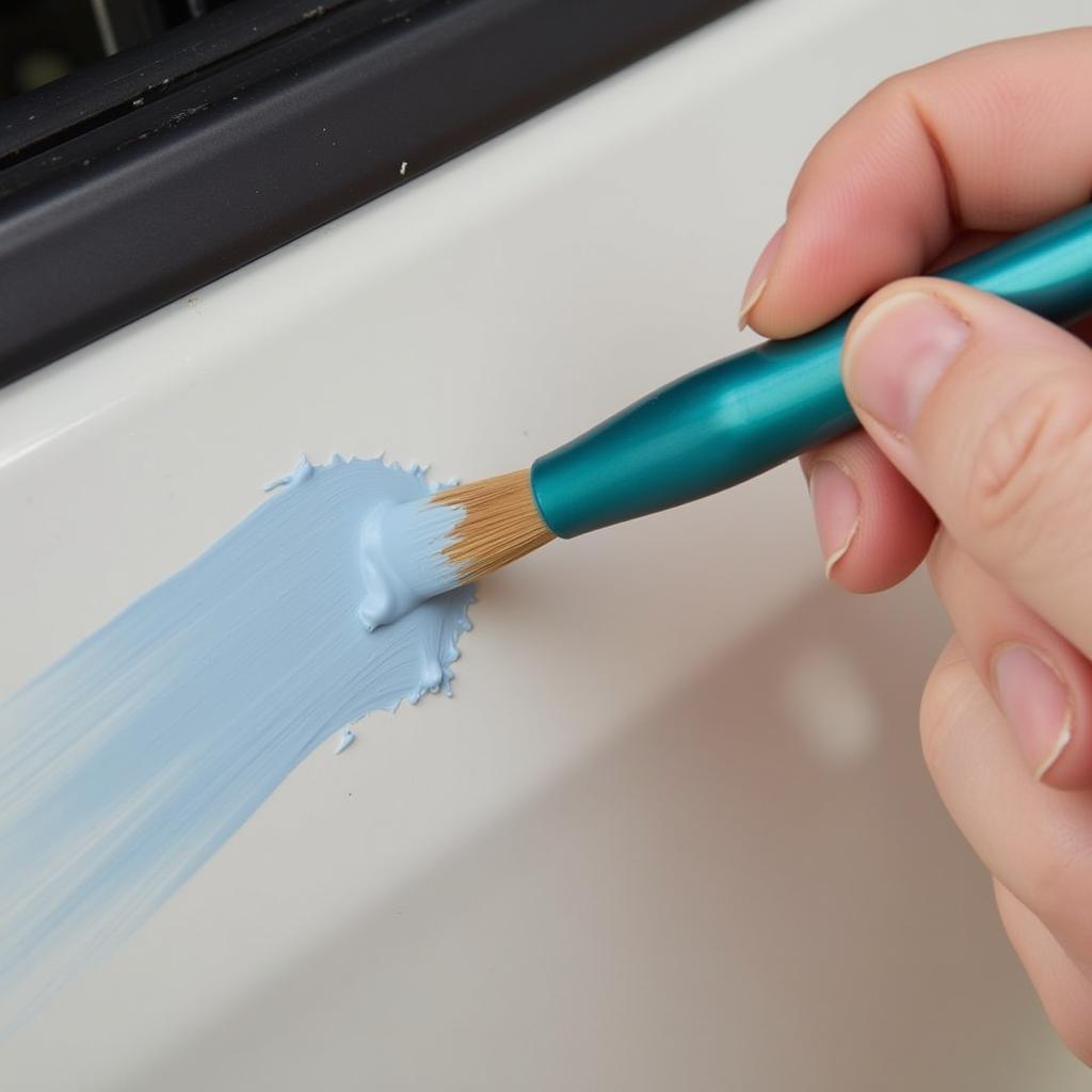 Applying touch-up paint to a car paint chip