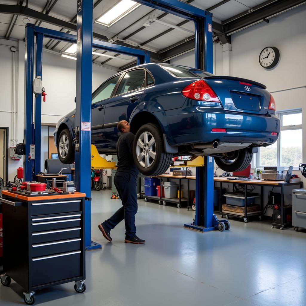 Car on a lift in a garage for inspection.