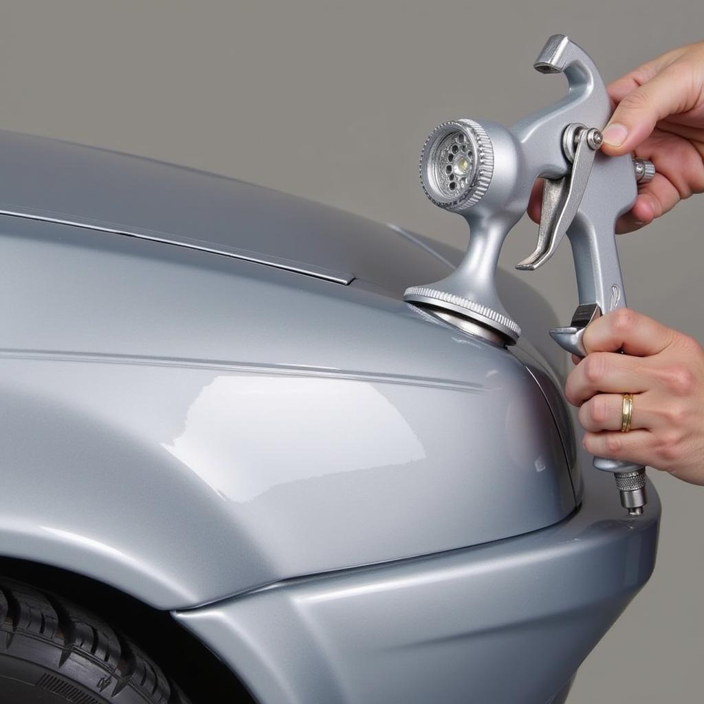 Applying car paint with a spray gun