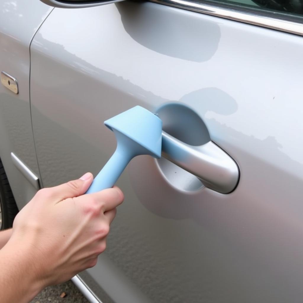 Using a plunger to fix a car door dent