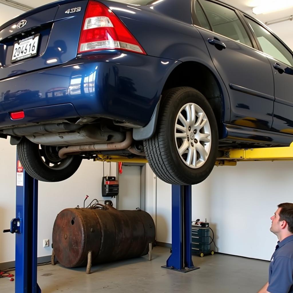 Mechanic Replacing a Damaged Car Fuel Tank