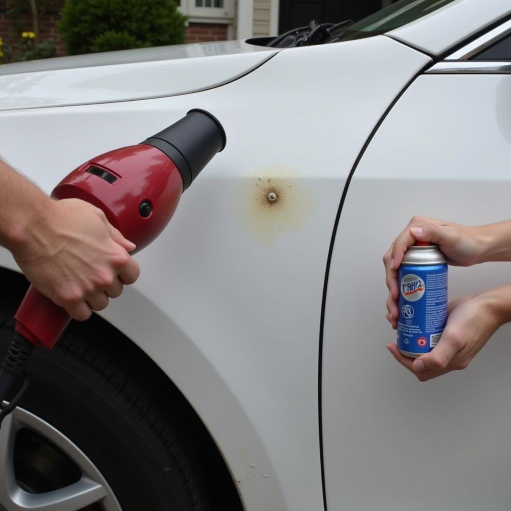 Using a hair dryer and compressed air to fix a car dent