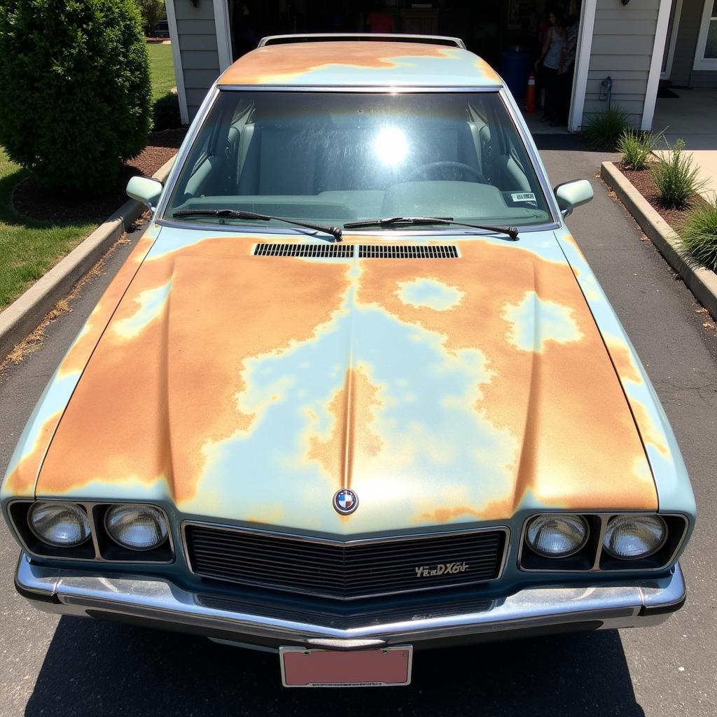 Car with faded paint parked in bright sunlight