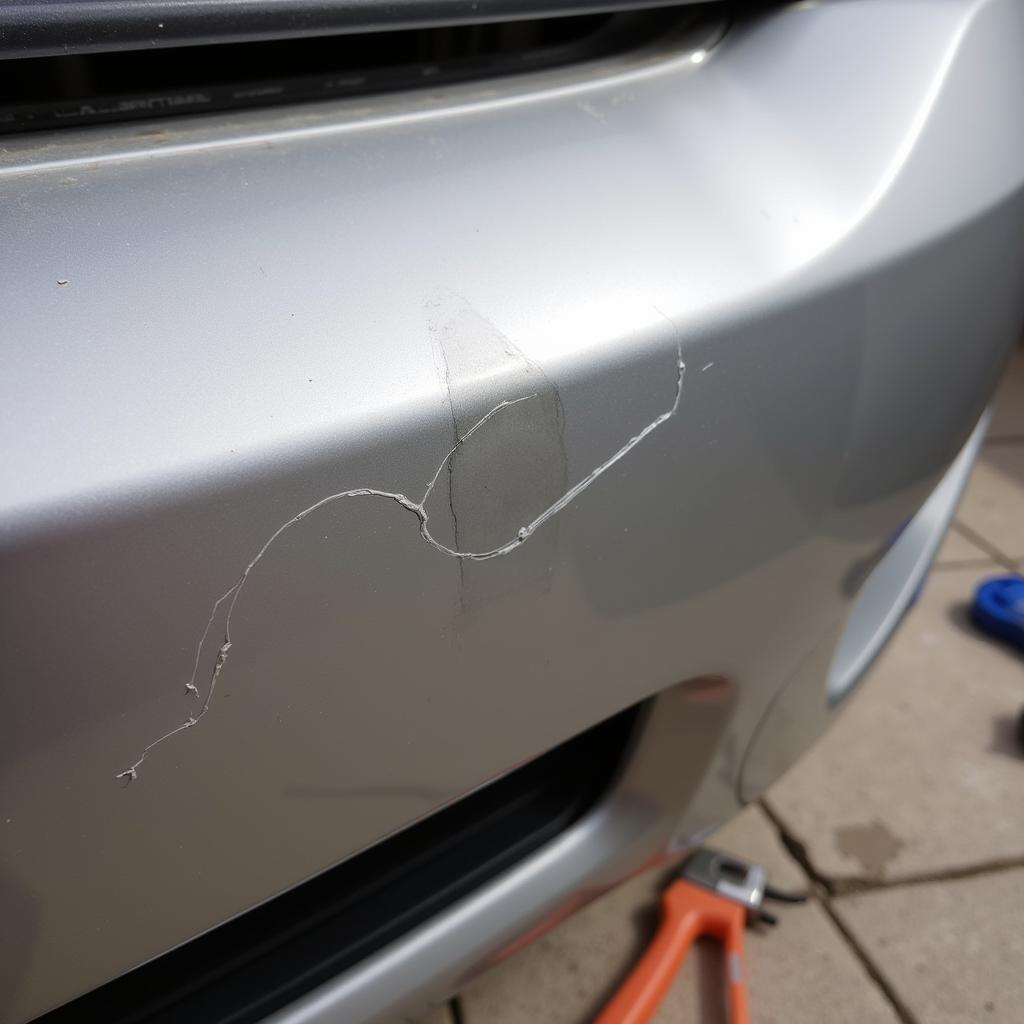 Deep scratch on car bumper repair