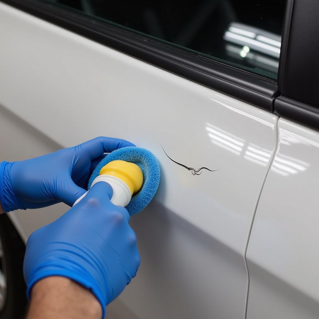 Applying Rubbing Compound to Car Scratch